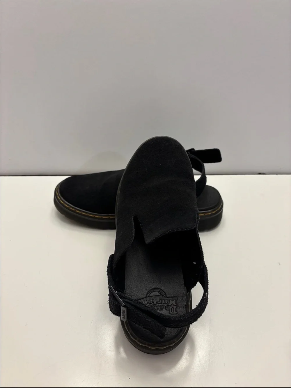 Dr. Martens Carlson slingback mules in black suede, with a chunky buckle